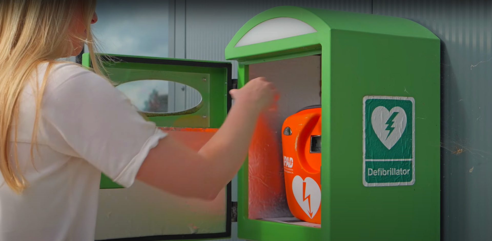 Person taking defibrillator from case