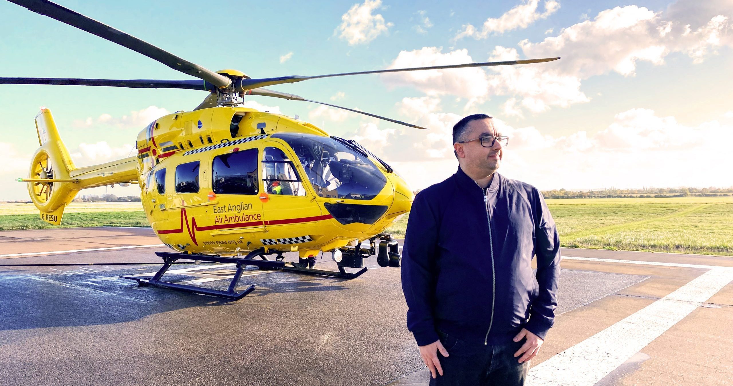 EAAA patient Jonathan Moran in front of helicopter